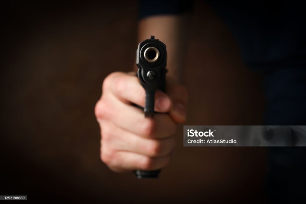 Man hold pistol. Selective focus. Robber. Violence