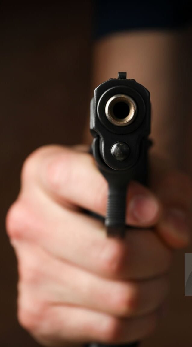 Man hold pistol. Selective focus. Robber. Violence